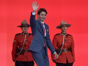 Prime Minister Justin Trudeau waves during the Canada Day noon hour show on Parliament Hill in Ottawa on Saturday, July 1, 2017. Justin Trudeau will skip Canada Day festivities on Parliament Hill this year. Instead, the prime minister will be on the road, celebrating Canada's 151st birthday in three cities in three different regions of the country.THE CANADIAN PRESS/Justin Tang