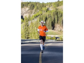 Dave Proctor runs in Sheep River Provincial Park, Alta. in this undated handout photo. Dave Proctor will soon dip his white cowboy hat into the Pacific Ocean and start his quest to run to the Atlantic in record time. Proctor intends to break the speed record for running across Canada, which is currently 72 days 10 hours set by Al Howie in 1991.THE CANADIAN PRESS/HO, Kurtis Kristianson, Outrun Rare *MANDATORY CREDIT*
