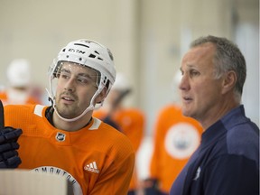 The Oilers first round pick Evan Bouchard speaks with Paul Coffey, a member of the Oilers coaching staff. The Edmonton Oilers are hosting the 2018 development camp in the downtown community arena in Rogers Place on Monday, June 25, 2018.