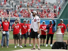 Washington Capitals' Alex Ovechkin, from Russia, celebrates after throwing out a second ceremonial first pitch before a baseball game between the Washington Nationals and the San Francisco Giants at Nationals Park, Saturday, June 9, 2018, in Washington.