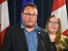 Farmer Albert Kamps, left, chairman of AgCoalition, speaks to the media after Labour Minister Christina Gray announced modernized health and safety rules to protect workers on farms and ranches at the Alberta legislature in Edmonton on Wednesday, June 27, 2018.