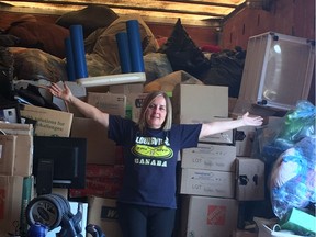 HEARTS founder Teresa Rocque poses in front of a heap of donated goods currently being stored in a semi-trailer until they are able to find open a new permanent location for their thrift centre to provide free essentials for Edmontonians in need of emergency support.