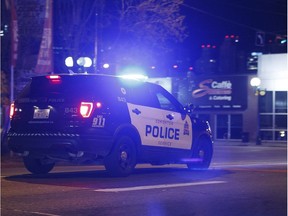 An Edmonton Police Service vehicle races downtown on 109 Street as police chase a U-Haul truck driven by a man who police say attacked an officer outside of an Edmonton Eskimos game at 92 Street and 107A Avenue in Edmonton, Alberta on Sunday, October 1, 2017. Police are cracking down on officers who drive aggressively outside of emergency situations.