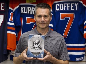 Wayne Wagner, owner of Wayne's Sports Cards in west Edmonton, holds a pack of Upper Deck The Cup cards, of which a recent online sale of a rare mint condition Connor McDavid The Cup rookie card recently sold for more than $55,000, at his shop on Tuesday, June 5, 2018.