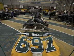 Clare Drake's hockey skates and a commemorative jersey signifying 697 wins are seen after a memorial for legendary University of Alberta Golden Bears hockey coach Clare Drake was held at the Butterdome in Edmonton, on Thursday, June 14, 2018.