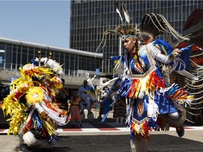 Dancers perform the men's fancy dance during an advance celebration of National Indigenous Peoples Day at Edmonton International Airport, on Wednesday, June 20, 2018.