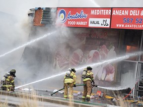 Edmonton fire crews battle a blaze at a strip mall in the area of Stony Plain Road and 154 Street on Monday, June 11, 2018.