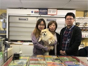 Ka Yung Jo (from left), Pome the dog, Meyoung Hee Han and Sung Hyun Jo stand behind the counter of the Fas Gas station in Thorsby, Alta. Ki Yun Jo, their husband and father, was killed trying to stop a gas and dash at the station last year.