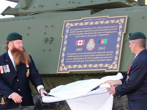 Mike Gray, 2nd vice-president of the Royal Canadian Legion Branch 165, and Martin Darveau, 1st vice-president of the branch, unveil a plaque commemorating Canadians who served in Afghanistan outside the legion in Waterways on Saturday, October 28, 2017.