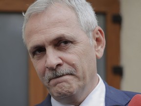 FILE - In this Friday, April 27, 2018 file photo, the leader of Romania's ruling Social Democratic party, Liviu Dragnea, grimaces as he walks out of the anti-corruption prosecutors' office, in Bucharest, Romania. A Romanian court has handed down a 3 ½ year prison sentence for the powerful leader of the ruling Social Democratic Party for official misconduct. The High Court of Cassation and Justice on Thursday, June 21 sentenced Liviu Dragnea, after two previous adjournments. The ruling can be appealed. There was no immediate comment from Dragnea.