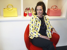 FILE - In this May 13, 2004, file photo, designer Kate Spade sits during an interview in New York. Kate Spade New York has announced plans to donate $1 million to support suicide prevention and mental health awareness causes in tribute to the company's late founder. The 55-year-old fashion designer killed herself June 5, 2018. Her husband says she suffered from depression and anxiety for many years.