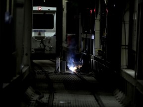 In this Wednesday, May 16, 2018 photo, a tunnel worker fixes "bumps" in the rail of a 2.5-mile bypass tunnel being dug for the Delaware Aqueduct, in Marlboro, N.Y. Hard-hat workers are toiling deep underground, 55 stories beneath the Hudson River, to eliminate gushing leaks in an aging tunnel that carries half the city's water supply over 85 miles from Catskill Mountain reservoirs.