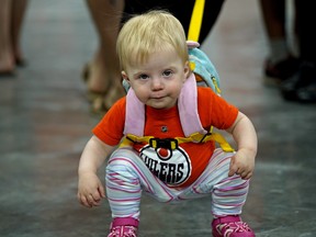 Veronica Elliott (18-months-old) takes a break while shopping with mom Lesley Dirkson at the 12th Annual Edmonton Oilers Locker Room Sale was held at Roger's Place in Edmonton on Sunday June 3, 2018. (PHOTO BY LARRY WONG/POSTMEDIA)