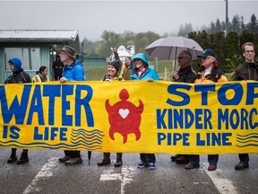 Protesters opposed to the Kinder Morgan Trans Mountain Pipeline expansion prevent a truck from leaving the company's facility, in Burnaby, B.C., on Saturday April 28, 2018.