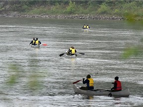 A group canoers head downstream on the North Saskatchewan River in the rain in Edmonton, June 1, 2018. Ed Kaiser/Postmedia