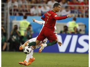 Portugal's Cristiano Ronaldo, collides with Iran's Alireza Jahanbakhsh during the group B match between Iran and Portugal at the 2018 soccer World Cup at the Mordovia Arena in Saransk, Russia, Monday, June 25, 2018.