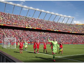 Canada goalie Erin McLeod, centre, waves as she leads her teammates around the stadium after defeating China during FIFA Women's World Cup soccer action at Commonwealth Stadium in Edmonton on June 6, 2015. Edmonton is in the running to host games of the 2026 FIFA World Cup.