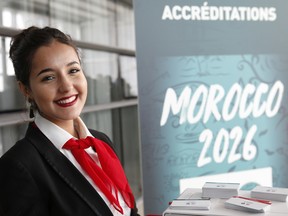 Moroccan hostess Zainab Rchid welcomes media before a press conference to promote Morocco's bid for the 2026 soccer World Cup, in Casablanca, Morocco.