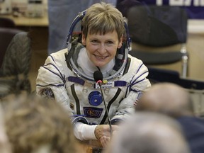In this Nov. 17, 2016 file photo, U.S. astronaut Peggy Whitson, member of the main crew of the expedition to the International Space Station (ISS), speaks with her relatives prior the launch of Soyuz MS-3 space ship at the Russian leased Baikonur cosmodrome, Kazakhstan. On Friday, June 15, 2018, NASA announced Whitson, who has spent more time off the planet than any other American, has retired. The 58-year-old biochemist joined NASA as a researcher in 1986 and became an astronaut in 1996. Her last spaceflight was in 2017.