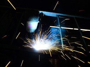 A welder fabricates a steel structure at an iron works facility in Ottawa on March 5, 2018. Following the G7 meetings in Quebec on Saturday, Trudeau said newly imposed U.S. tariffs on steel and aluminum were insulting.