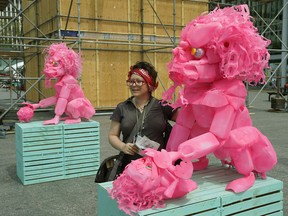 Christyna Rokicki checks out some art work by artist Yong Fei Guan at The Works Art and Design Festival in downtown Edmonton on Monday June 25, 2018. The festival has moved from Churchill Square to Centennial Plaza. (PHOTO BY LARRY WONG/POSTMEDIA)