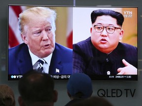 In this May 24, 2018, file photo, people watch a TV screen showing file footage of U.S. President Donald Trump, left, and North Korean leader Kim Jong Un during a news program at the Seoul Railway Station in Seoul, South Korea.