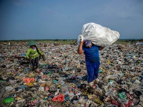 People collect valuable waste at Sidoarjo garbage dump in East Java, on June 5, 2018. About eight million tonnes of plastic waste are dumped into the world's oceans every year. Over half comes from five Asian countries: China, Indonesia, the Philippines, Thailand and Vietnam, according to a 2015 study in Science journal.