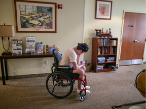 Ryan Straschnitzki kills time by going on his phone at Ronald McDonald House in Philadelphia on Tuesday June 26, 2018.