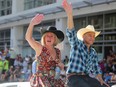 Premier Rachel Notley and Alberta Finance Minister Joe Ceci wave to the crowd during the 2018 Calgary Stampede Parade on Friday, July 6, 2018.