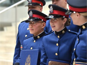 Graduate Cst. Duy Luu (L) posing for a photo with fellow graduates that will be stationed with him at downtown division, after the Edmonton Police Service graduation ceremony of recruit training class No. 141 at City Hall in Edmonton, July 27, 2018. Ed Kaiser/Postmedia