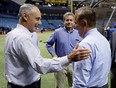 Baseball Commissioner Rob Manfred, left, and Tampa Bay Rays owner Stuart Sternberg, center, meet St. Petersburg Mayor Rick Kriseman before a baseball game between the Rays and the Toronto Blue Jays on Wednesday, Aug. 23, 2017, in St. Petersburg, Fla.