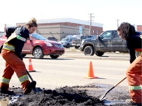 Workers fix potholes in Grande Prairie.