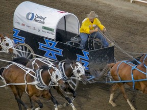 Chanse Vigen driving for dad Mike Vigen heads for the finish in Heat 9 at the Calgary Stampede Rangeland Derby in Calgary, Ab., on Wednesday July 11, 2018. Mike Drew/Postmedia