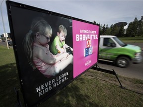 Motorists make their way past an Edmonton Police Service billboard along 111 Avenue near 142 Sreet in Edmonton. Heat warnings have been issued for Edmonton and much of Alberta.