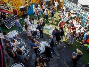 People enjoy the patio during the unveiling of Okuda San Miguel's mural at El Cortez in Edmonton.