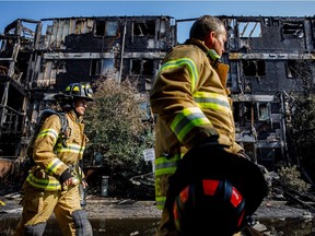 Firefighters investigate at the scene of a fire in the Blue Quill neighbourhood in Edmonton on Sunday, July 29, 2018.