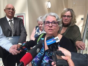 City of Edmonton accounts payable office co-ordinator Darlene Woodham speaks to the media about past harassment in her place of work. Behind her are Civic Service Union 52 president Lanny Chudyk, left, and Woodham's coworkers Helena MacDonald and Deb Dochniak.