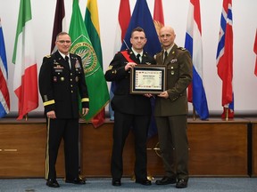 Supreme Allied Commander Europe, Gen. Curtis Scaparrotti, left, and Command Sgt. Maj. Davor Petek, right, present Canadian Forces Sgt. Marc Hall with the Allied Command Operations Military Member of the Year Award.