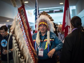 Assembly of First Nations National Chief Perry Bellegarde holds the eagle staff as he waits to lead the grand entry at the opening of the AFN Annual General Assembly, in Vancouver on Tuesday, July 24, 2018.