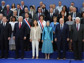 From left, former foreign minister John Baird, former prime minister Stephen Harper, Colombian-French politician and former senator Ingrid Betancourt, leader of the People's Mujahedin of Iran Maryam Rajavi, former mayor of New York City and attorney to President Donald Trump Rudolph Giuliani, and former US Speaker of the House Newt Gingrich pose in the front row for a picture during the meeting "Free Iran 2018 - the Alternative", organised by the People's Mujahedin of Iran near Paris June 30, 2018.