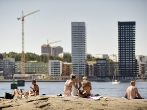 People sunbath in the center of the Swedish capital Stockholm on June 16, 2018.