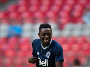 Vancouver Whitecaps' Alphonso Davies laughs while warming up with his teammates before a CCL match against Sporting Kansas City at B.C. Place in August 2016.