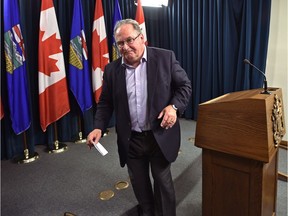 Transportation Minister Brian Mason walks away from the podium after announcing he will not run in the next provincial election during a news conference at the Alberta legislature in Edmonton on Wednesday, July 4, 2018.