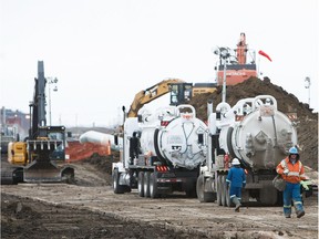 Crews clean up at the site of a pipeline spill near 92 Avenue and Anthony Henday Drive in Edmonton on Feb. 18, 2017.
