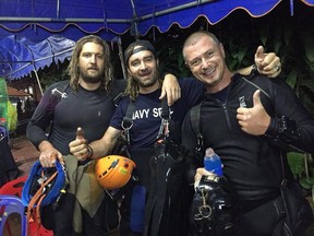 British Columbia-born diver Erik Brown, left, poses with fellow divers Mikko Paasi, centre, and Claus Rasmussen, in a July 10, 2018, handout image. The photo was posted to Facebook with the caption, "9 days. 7 missions and 63 hours inside Tham Laung Cave. Success."