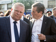 Ontario Premier Doug Ford, left, and Toronto Mayor John Tory take part in a vigil to honour the victims of a deadly shooting in Toronto, July 25, 2018.