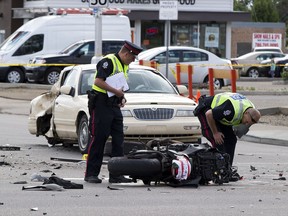 Police investigate the scene of a fatal car, motorcycle crash at the corner of 101 Avenue and 75 Street on Sunday, July 22, 2018 in Edmonton.