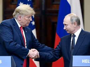 U.S. President Donald Trump and Russian President Vladimir Putin shake hands during a join press conference at the Presidential Palace in Helsinki, Finland, Monday, July 16, 2018. (Jussi Nukari/Lehtikuva via AP) ORG XMIT: LET215