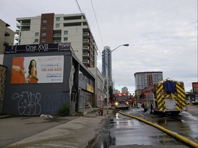 Police closed down Jasper Avenue from 116 Street to 118 Street as firefighters tackle a blaze at a two-storey commercial building on Wednesday, July 11, 2018.