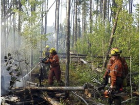Ontario Fire Ranger crews suppressing a fire in the far north of Red Lake District earlier this year. An Alberta firefighter has died fighting fires in the area.